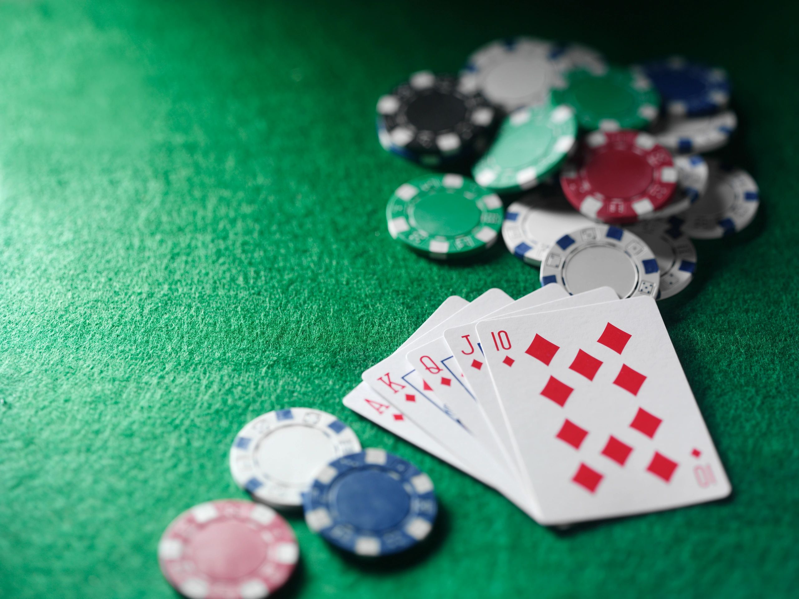 Royal flush poker hand on a green felt table
